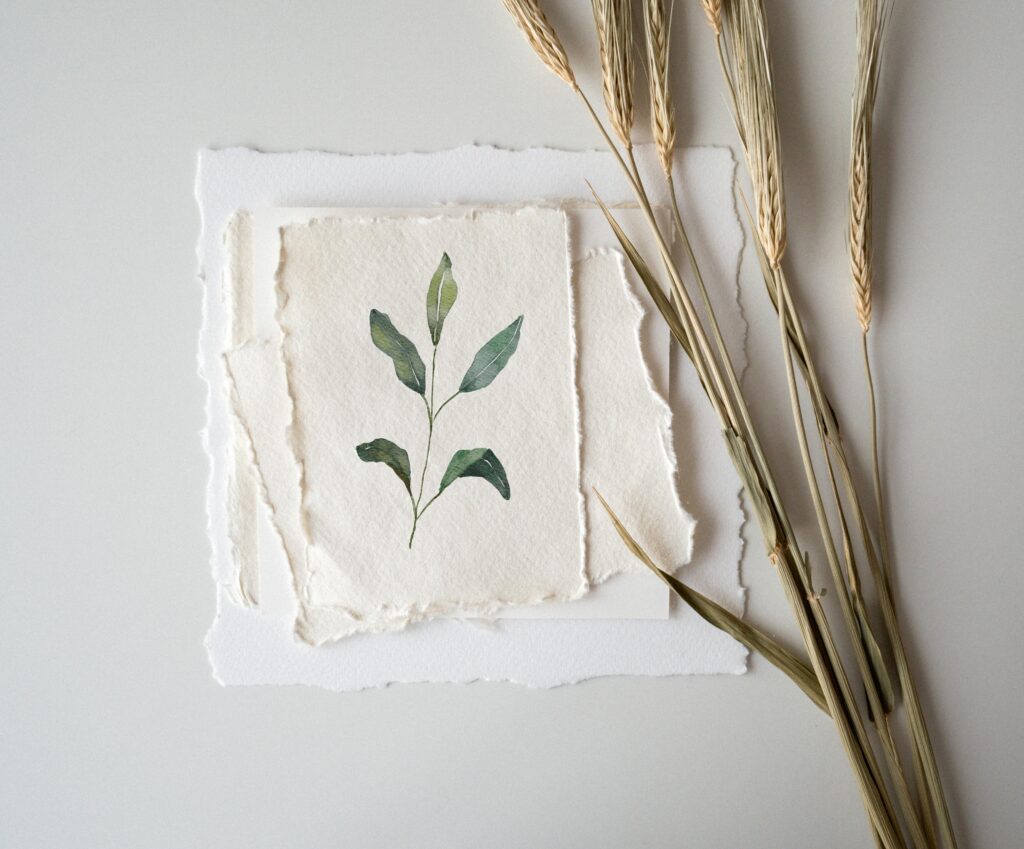 Elegant botanical watercolor painting displayed with wheat stalks for a minimalist look.
